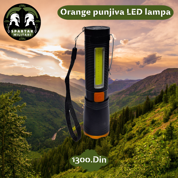 Orange punjiva LED lampa uspravno sa vidljivim COB i LED farom na planinskoj pozadini.
