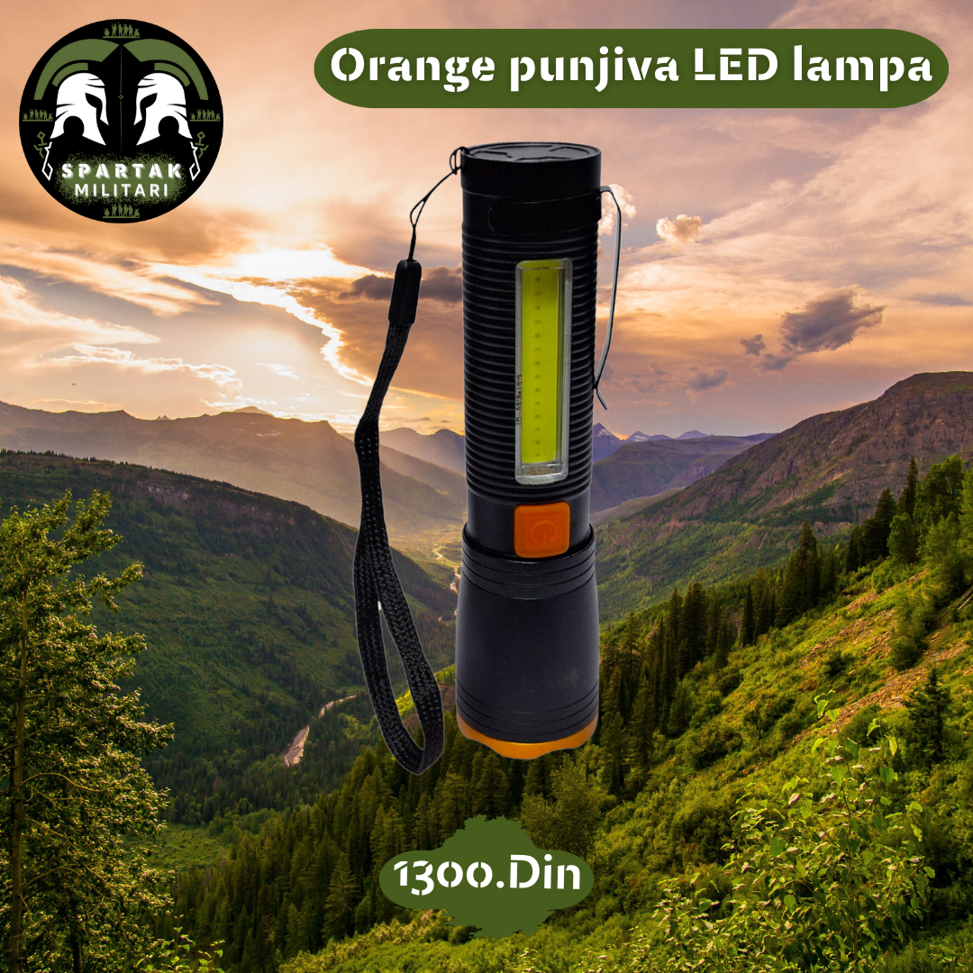 Orange punjiva LED lampa uspravno sa vidljivim COB i LED farom na planinskoj pozadini.